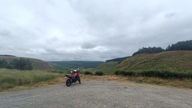 Red bike in lush green valley landscape